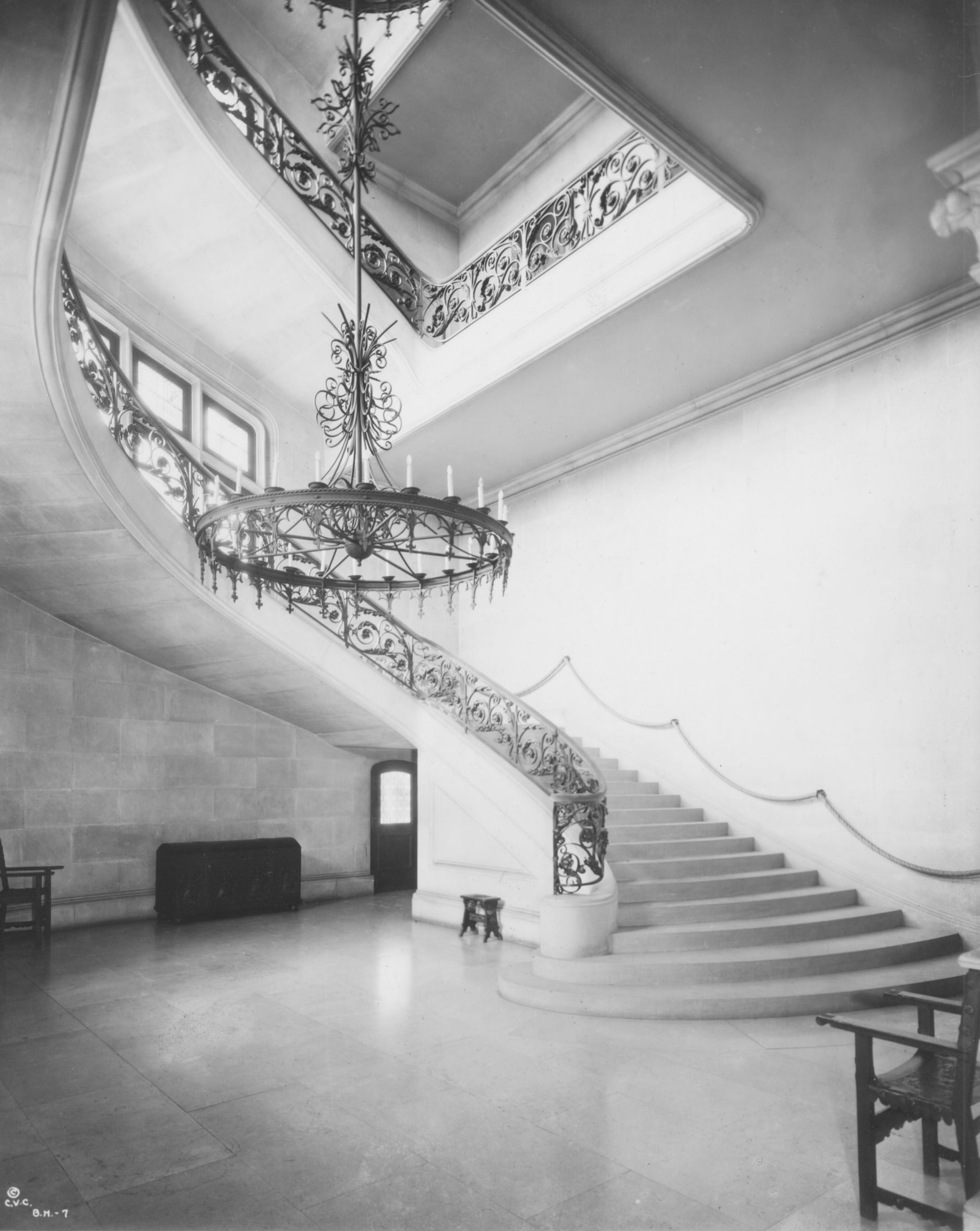 Historical photo of a grand staircase and chandelier at Biltmore