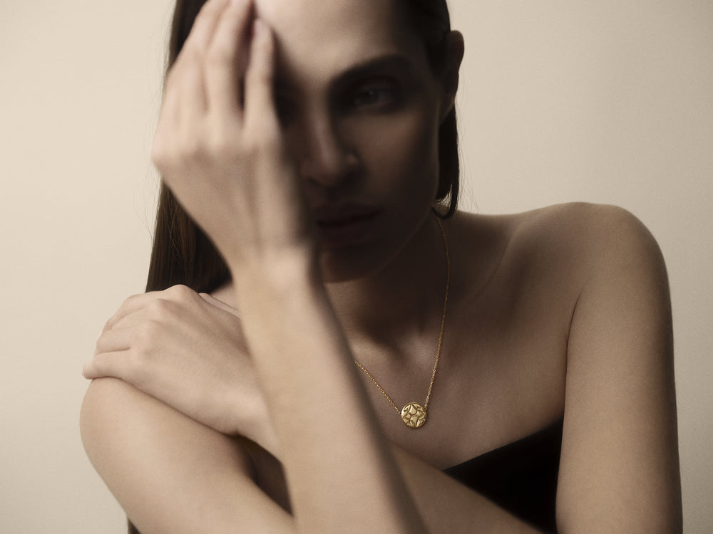 Portrait of a woman wearing an Oak Sitting pendant
