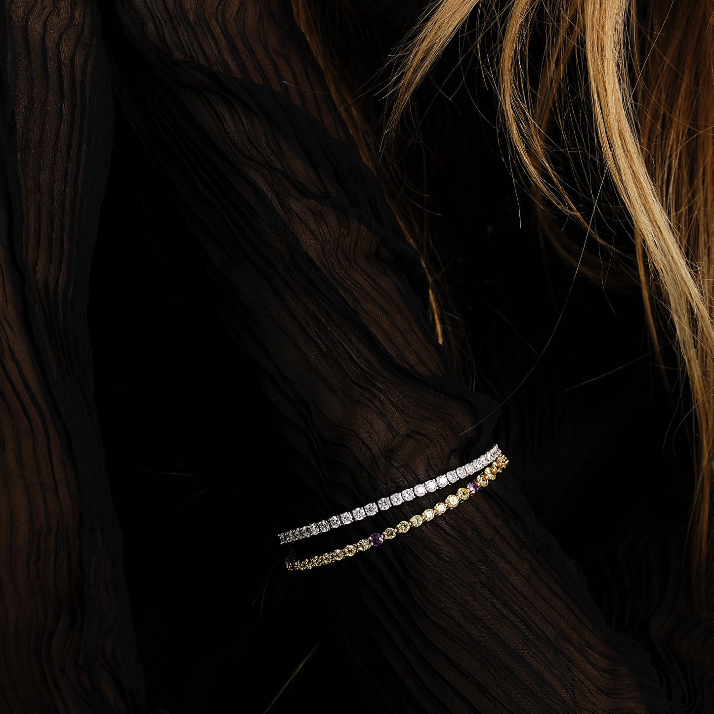 Close-up of a woman wearing the 18K Yellow and Purple Sapphire Tennis Bracelet