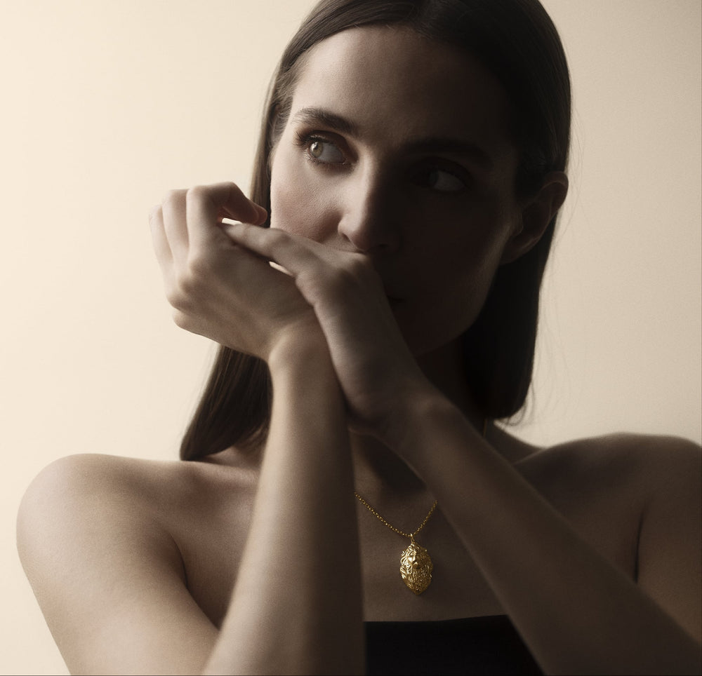 Portrait of a woman wearing a gold Commodore pendant