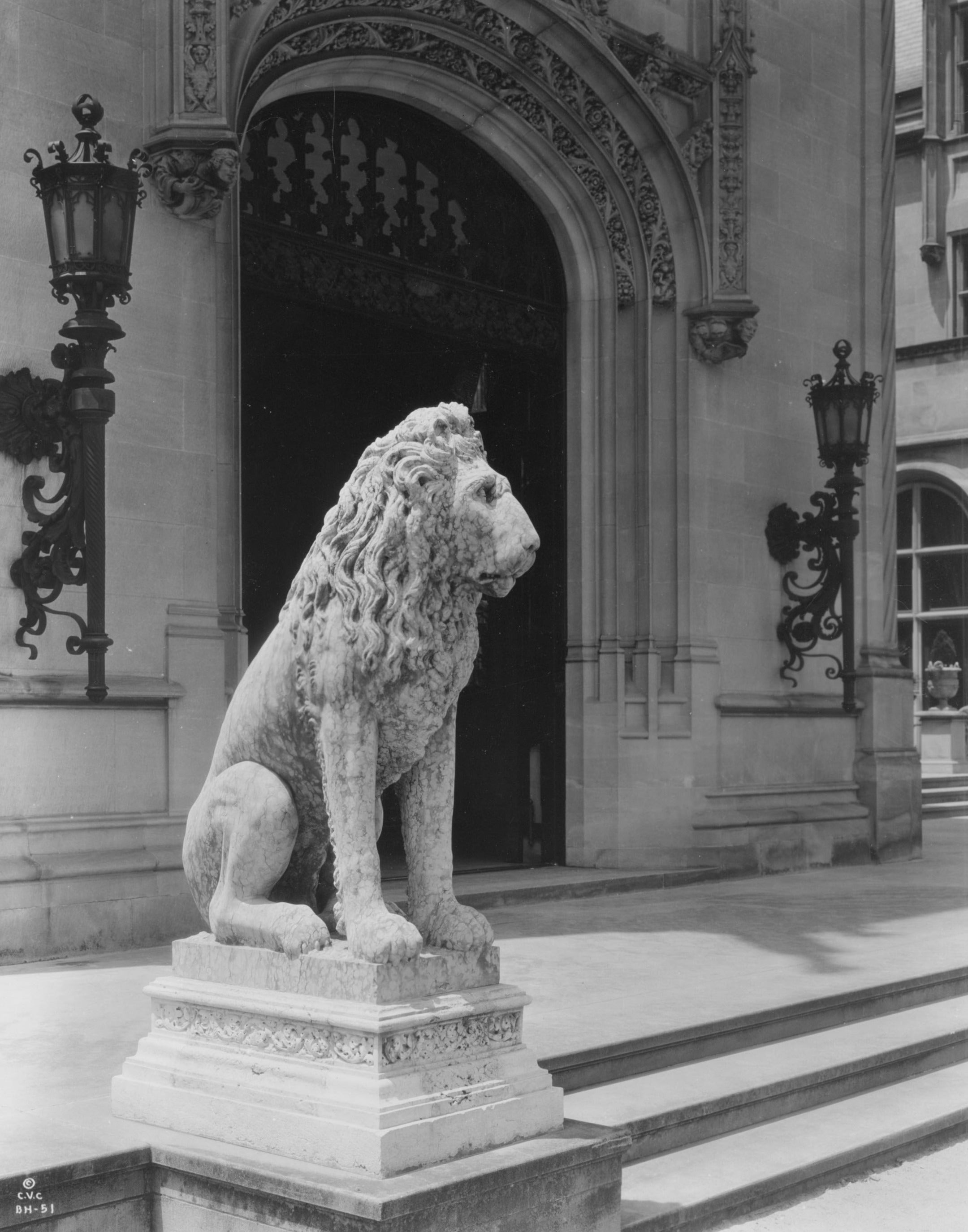 Historical photo showing one of the stone lions outside Biltmore