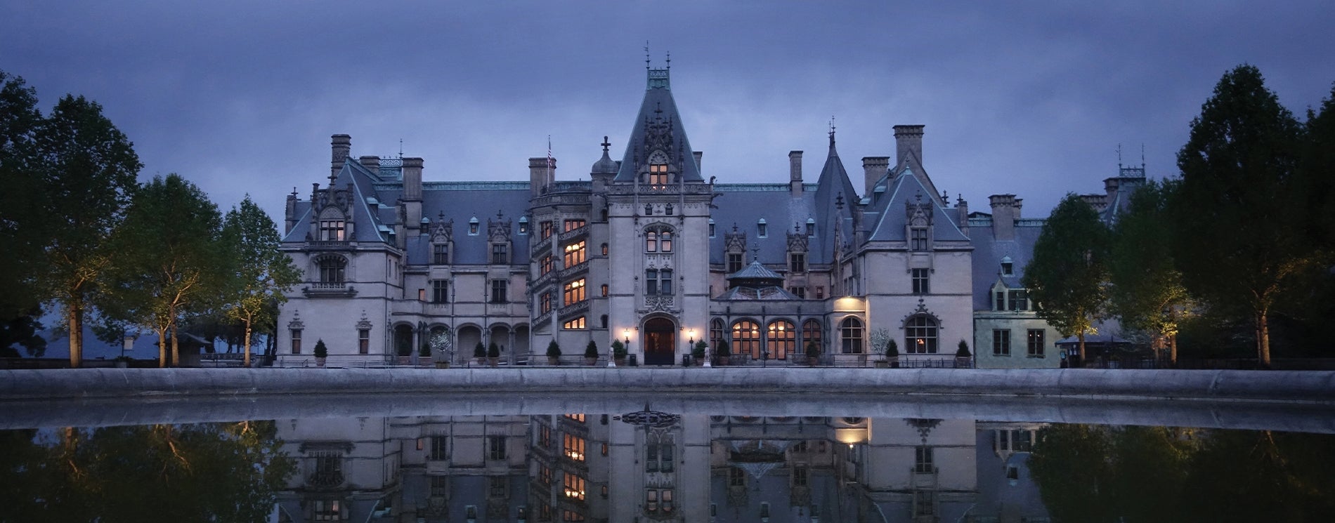 Biltmore mansion in the evening, reflecting in a pool